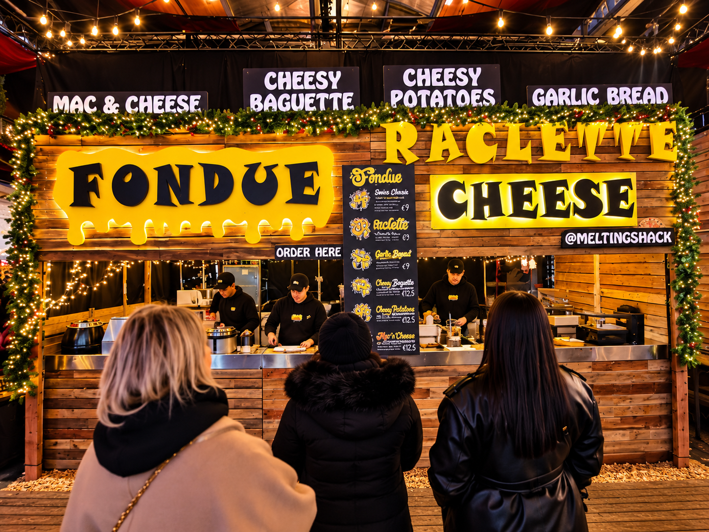 The Fondue and Raclette Cheese signs lit up above the counter with customers ordering