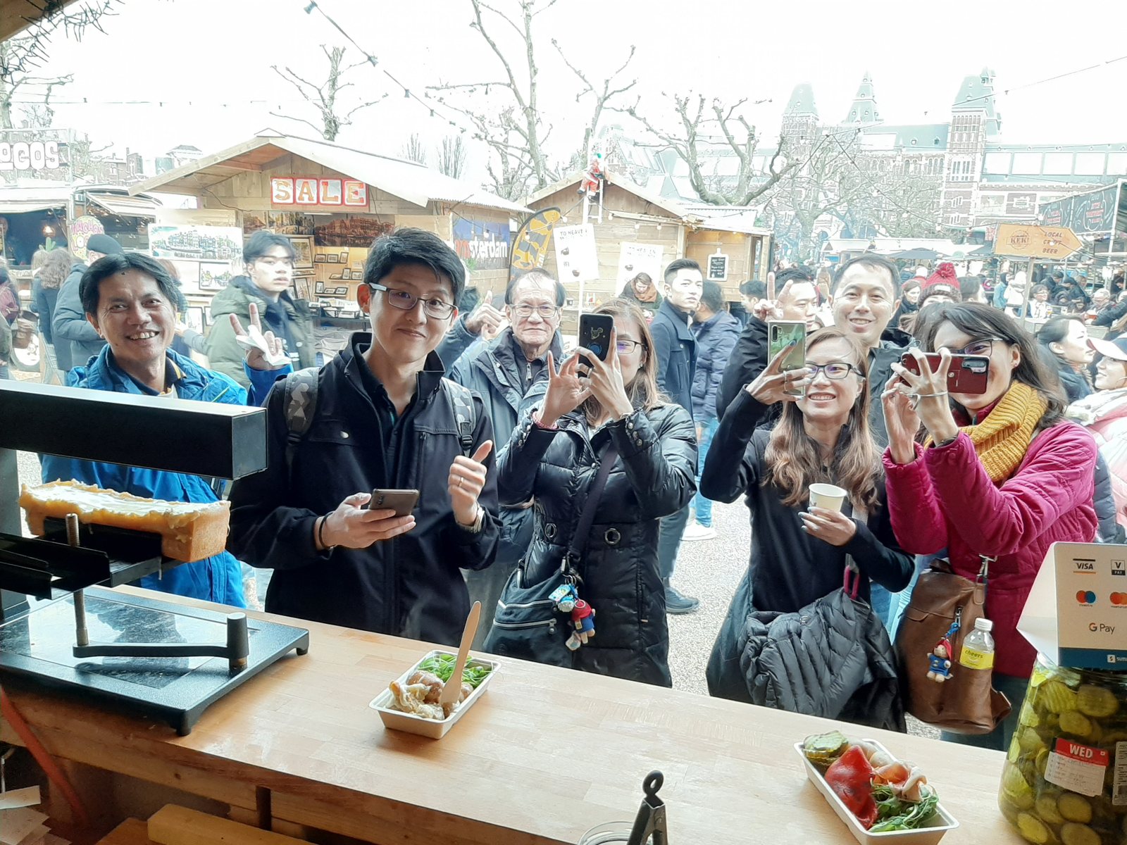 Customers gathered at the counter waiting for raclette